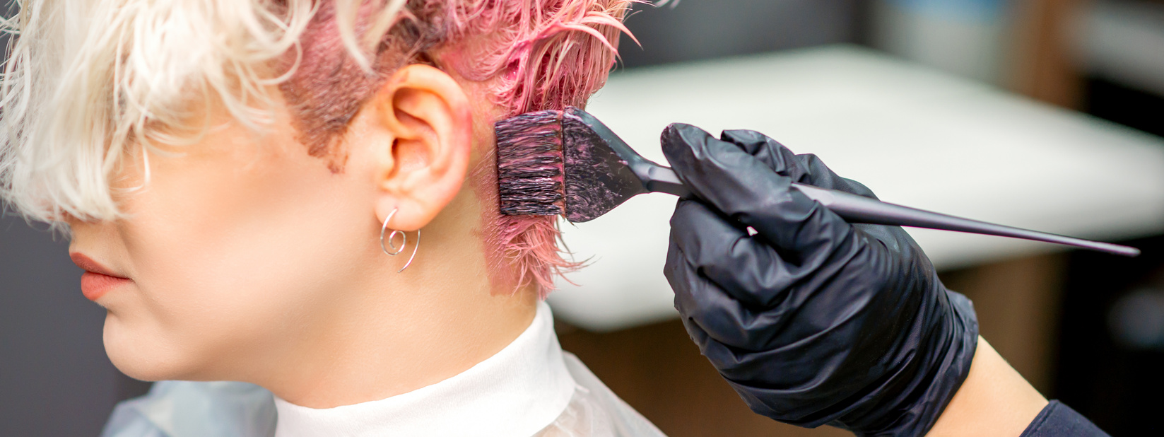 Hairdresser Dyeing Hair in Pink Color